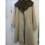 A vintage Sottozero full length ladies coat with a tan exterior and a removable rabbit fur lining