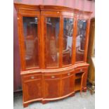 A large modern yew wood display cabinet with glazed doors above a brushing slide with four drawers