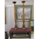 An oak stool with an upholstered top and a pair of modern hardwood candle stands