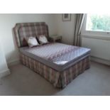 A modern double 4 drawer divan bed with padded headboard, matching valance and cushions.