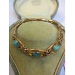 A 9ct gold bracelet inset with three turquoise