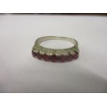 An 18ct white gold seven stone ruby ring