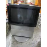 A Bang & Olufsen television with remote, 40"h x 28 1/2"w