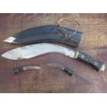 A Kukri with an inlaid hardwood handle in a leather clad sheath