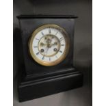 An early 20th century black slate mantle clock with key