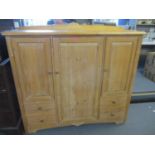 A modern M & S pine cupboard having four short drawers and three cupboard doors, 47" x 53" x 18"