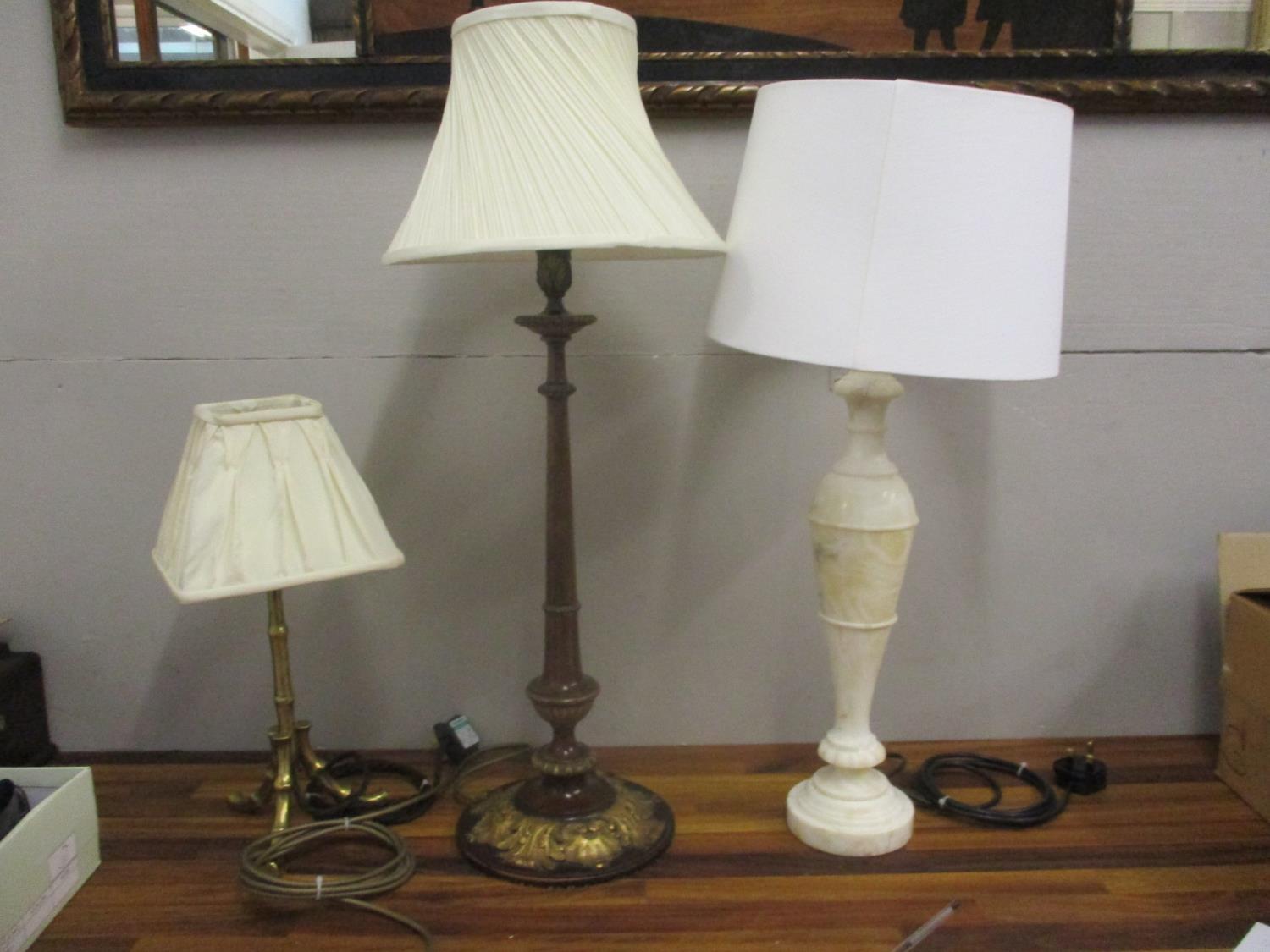 Three vintage lamps to include a carved gilt mahogany table lamp with acanthus ornament, an