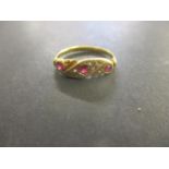 A gold coloured metal diamond and ruby ring, stamped 18ct, 2.25g