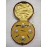 A cased early 20th century silver and enamelled dress stud set