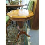 A Victorian walnut games/sewing table, inlaid octagonal hinged top with chequerboard and scrolled,