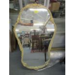 An Ansonia white painted framed wall mirror with gilt highlights and flower head decoration, label