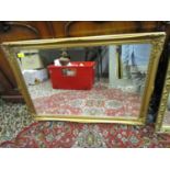 A gilt framed wall mirror of rectangular form with bevelled glass plate, 23 1/2" x 33 2/8"