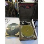 An early 20th century wind up gramophone with a selection of 78rpm records