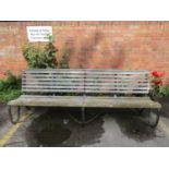 An iron framed and oak slatted garden bench, 34"h x 96" x 27"