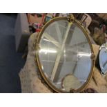 A neo-Classical inspired gilt circular wall mirror, 45" diameter
