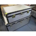 Three silver luggage trunks