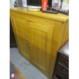 A large modern light oak twin door cabinet with three loose shelves 48"h x 47 1/2"w