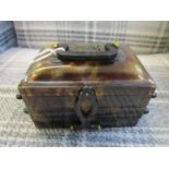 An oriental tortoiseshell cantilever action box with carved dragon decoration and carrying handle
