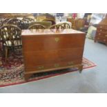 A 19th century mahogany chest with a hinged top over two drawers with brass side handles, on bracket