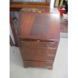 A reproduction mahogany ladies bureau having fall flap above four drawers