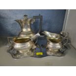 A silver plated three piece teaset with sugar tongs, gravy boat and a tray