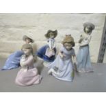 A group of five Lladro porcelain figurines to include a girl cuddling a dog