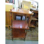 A Victorian mahogany three tier what not on turned legs and brass castors, 34" h