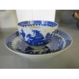 A Worcester 18th century blue and white tea bowl and saucer, decorated in the Fisherman and