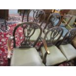 A set of five 1920s mahogany dining chairs with carved and pierced splats, the upholstered seats