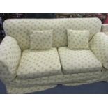 Circa 1900, a three-seater drop end sofa with later upholstery standing on square tapering legs