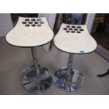 Two modern swivel topped bar stools