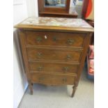 A mid 20th century French marble topped four drawer chest of drawers standing on tapered fluted legs