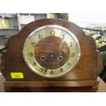 An Art Deco style 1930s oak cased mantel clock with silvered Arabic chapter ring, with key and