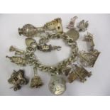 A silver charm bracelet with loose charms