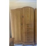 A mid 20th century South African hardwood wardrobe having one long door flanked by one small