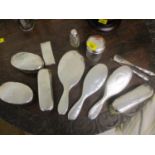 Twelve silver backed and lidded dressing table items with spot hammered decoration to include