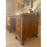 A mid 20th century South African hardwood desk having six short drawers and standing on ball and