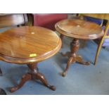 A pair of reproduction cherry wood lamp tables on tripod bases