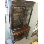An early 20th century French mahogany display cabinet having four glazed doors and two front