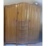 A mid 20th century South African hardwood triple wardrobe, standing on ball and claw feet, 79 1/2"