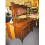 An oak Arts and Crafts sideboard circa 1900, retailed by Liberty in 1997, the mirrored back with