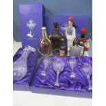 An unused Edinburgh crystal decanter and four wine glasses in two presentation boxes, together