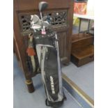 A golf bag containing golf clubs to include Spalding