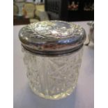 An early 20th century cut glass dressing table jar with silver top, hallmarked Birmingham 1906