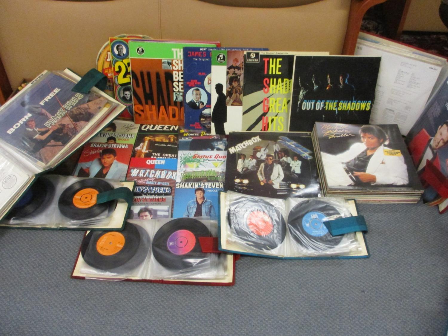 A collection of 1950s - 1980s records to include Shakin' Stevens, Queen and Freddie Mercury 45rpms