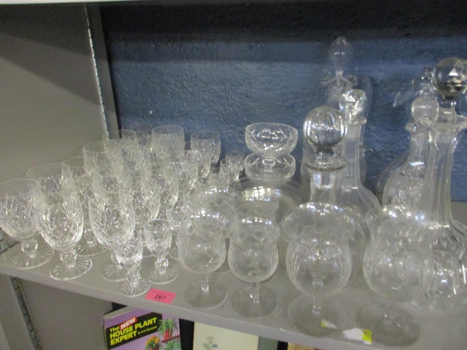 A quantity of Waterford lead crystal glasses, together with early 20th century decanters, etched