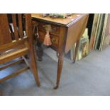 A Victorian mahogany Pembroke table with two short drawers to one side and two short false drawers