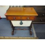 An early Victorian mahogany work table with single drawer and a pleated silk basket below.