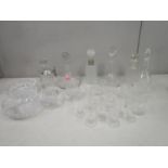 A selection of cut and pressed table glass to include ships decanters and etched and cut drinking