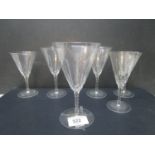 An early 20th century Powell (Whitefriars) glass-cut flame set of drinking glasses of various sizes,